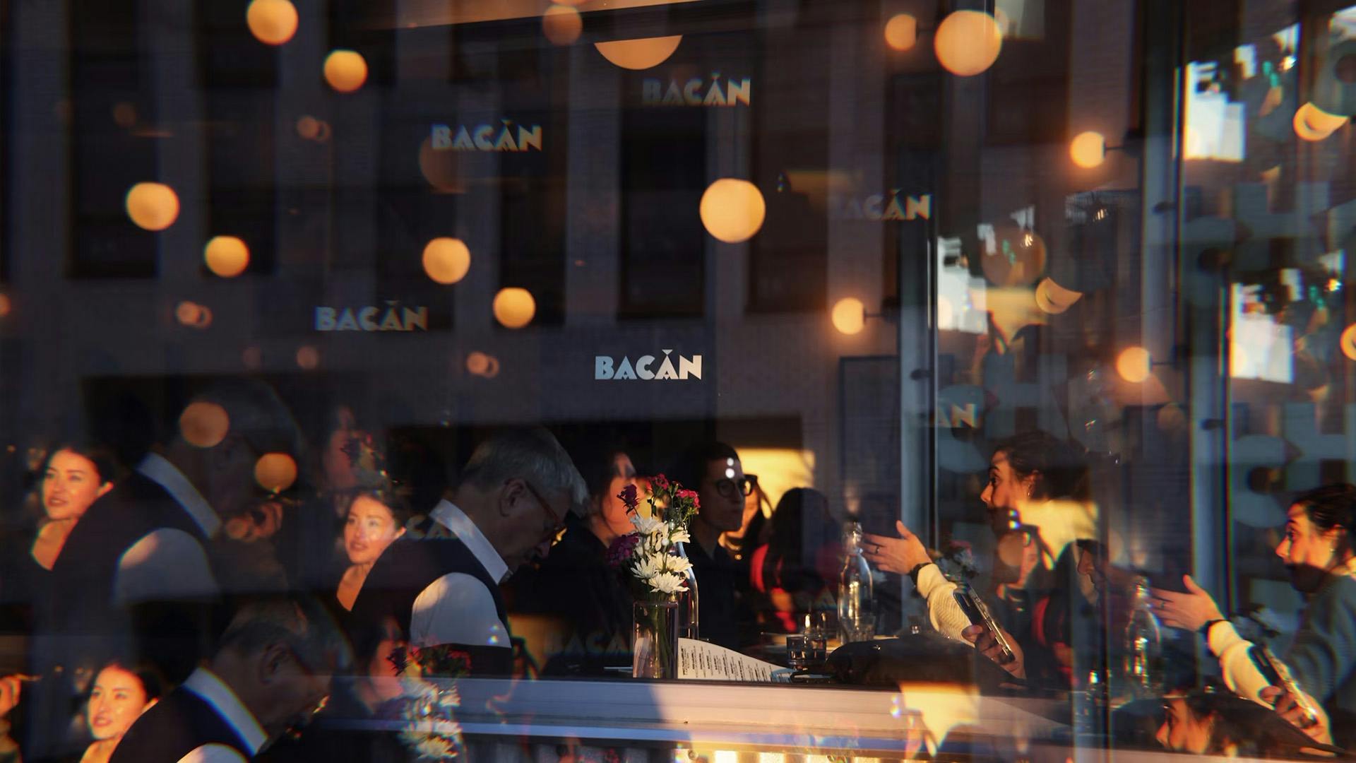 The word Bacan displayed on a restaurant window