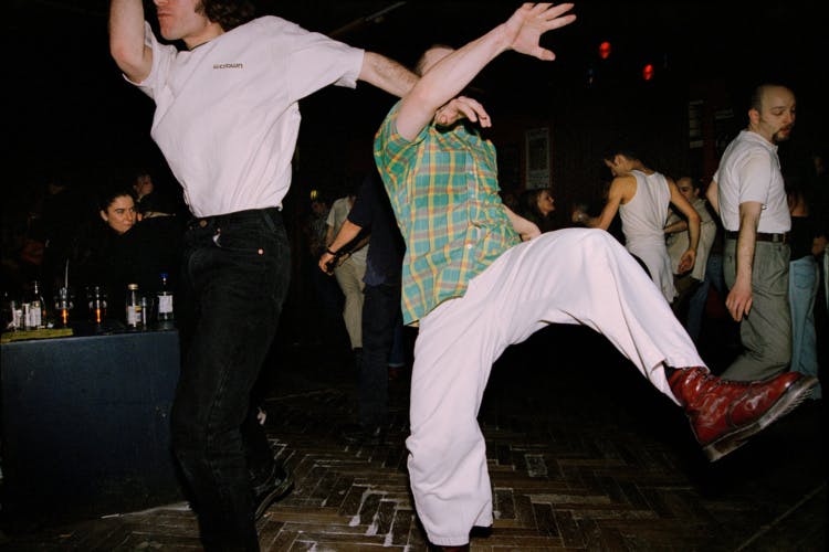 Two people dancing exuberantly in a hall